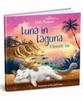 Children's book titled 'Luna in Laguna: A Seaside Tale' by Leah Huganir, illustrated by Paulina Flackman. The cover features a colorful sunset seascape with a white cat sleeping on a wooden ledge in the foreground.