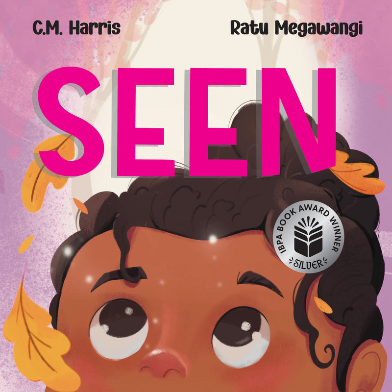Book cover of 'SEEN' with a child's face and colorful leaves on a pink background